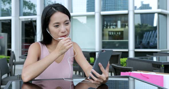 Woman Using Cellphone in Outdoor Cafe