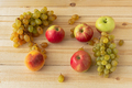 Apples grapes peaches on a wooden beige background - PhotoDune Item for Sale