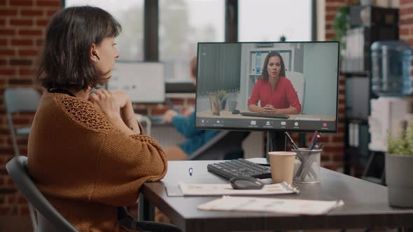 Employee Waving at Video Call Camera to Talk to Manager