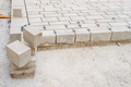 Paving a street with stone pavers, construction work in progress. - PhotoDune Item for Sale