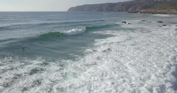 Aerial view of a bodyboarder paddling out at the Guincho Beach, in Cascais, Portugal. amazing waves