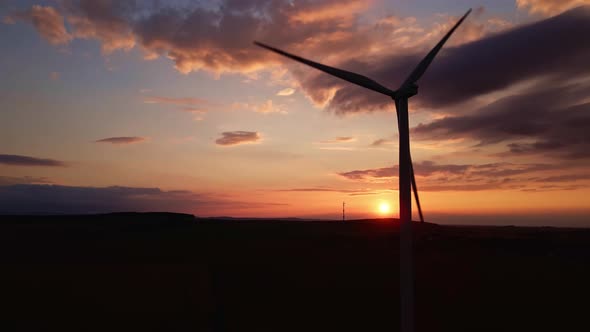 Silhouette of Windmill Turbine in Field at Sunset Sky