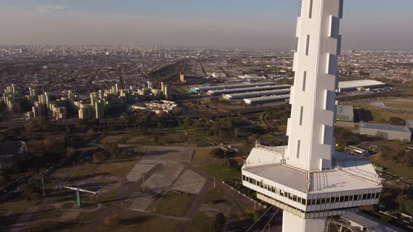 Aerial orbiting shot of Torre espacial Tower at Sector Futuro amusement park in Buenos Aires