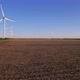 Windmills in a plowed field. Wind farm with turbine cables for wind energy. - VideoHive Item for Sale