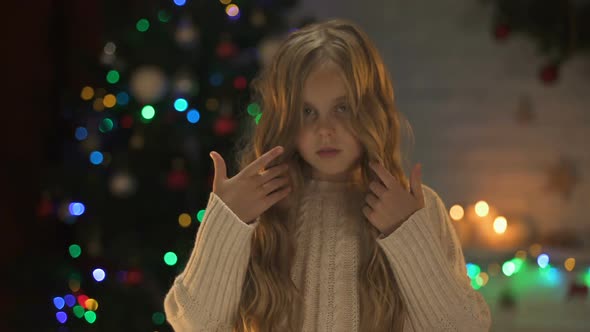 Sad Abandoned Girl Looking to Camera Waiting New Family in Orphanage, X-Mas Time