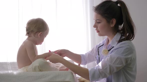 Little Child at Doctor on Medical Checkup, Professional Pediatrician Woman Examines Sweet Baby Boy