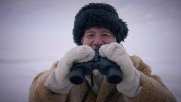 Front View Bearded Senior Man with Binoculars Smiling Looking at Camera