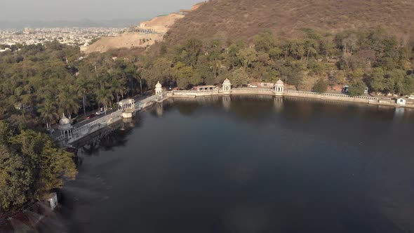 Udaipur lake Pichola bank surrounded by stone dam in Rajasthan, India - Aerial Panoramic shot
