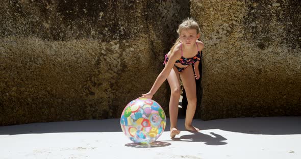 Girl playing with ball in the beach 4k