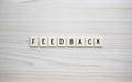 Feedback letter tiles on a wood grain background - PhotoDune Item for Sale