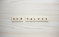 Our Values letter tiles on a wood grain background - PhotoDune Item for Sale
