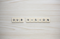 Our Vision letter tiles on a wood grain background - PhotoDune Item for Sale