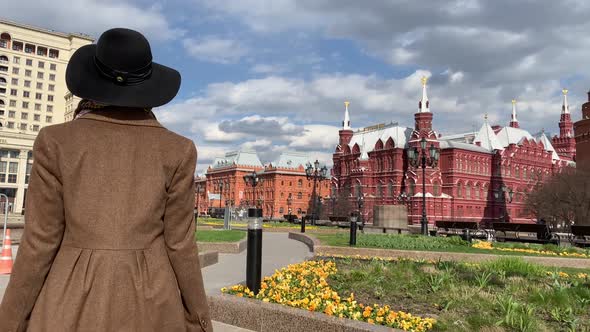 Elegant woman in hat walking on Red Square near Historical Museum, Kremlin, Red Square Moscow Russia