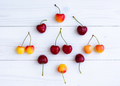Composition of cherries on a white wooden background top view. - PhotoDune Item for Sale