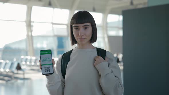 Woman Showing Digital Vaccine Certificate on Mobile Screen