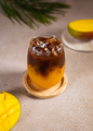 Cold mango and coffee cocktail with ice. Summer party or bar menu concept. - PhotoDune Item for Sale