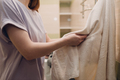 A woman wipes herself with a towel in the bathroom after washing - PhotoDune Item for Sale