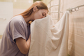 A woman wipes herself with a towel in the bathroom after washing - PhotoDune Item for Sale