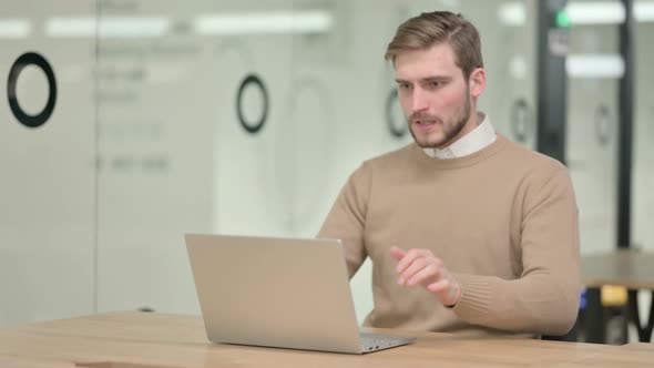 Creative Young Man Having Loss on Laptop in Office