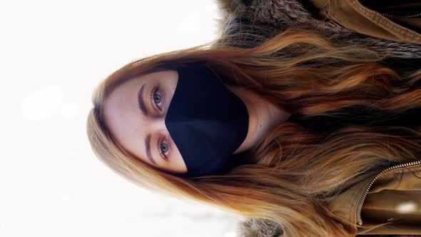 Woman Wearing Reusable Protective Mask in Winter