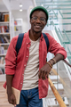 Portrait smiling happy african american student hipster guy with books in campus university library - PhotoDune Item for Sale