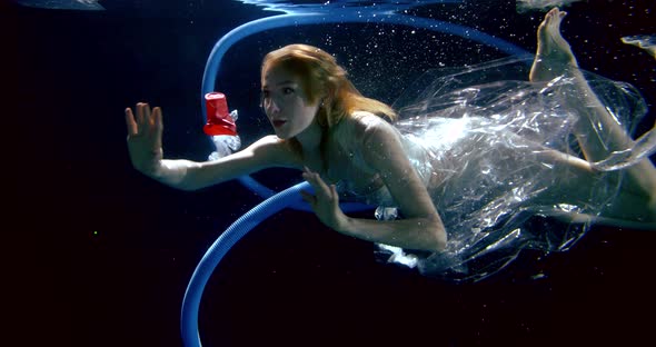 Underwater Shooting of Woman Floating Between Plastic Waste, Concept of Pollution of World Oceans