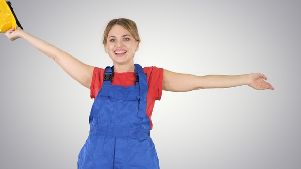 Female Construction Worker Dancing with Hardhat on Gradient