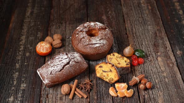 Christmas Composition of Dried Fruits and Stollen with Tangerine on a Wooden Textured Table with