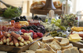 Beautiful charcuterie table set up for lunch with meats, cheeses, sandwiches, and vegetables. - PhotoDune Item for Sale