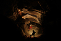 Spelunkers exploring an underground cave - PhotoDune Item for Sale