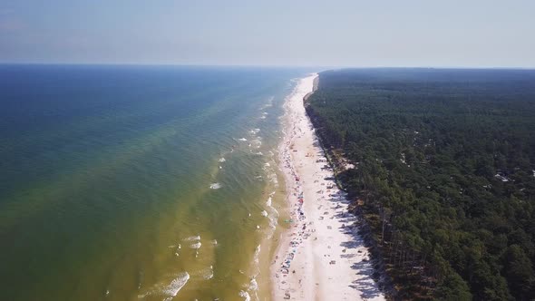 Drone footage of a sandy beach, sunny summer day, Baltic Sea, Poland, Lubiatowo.