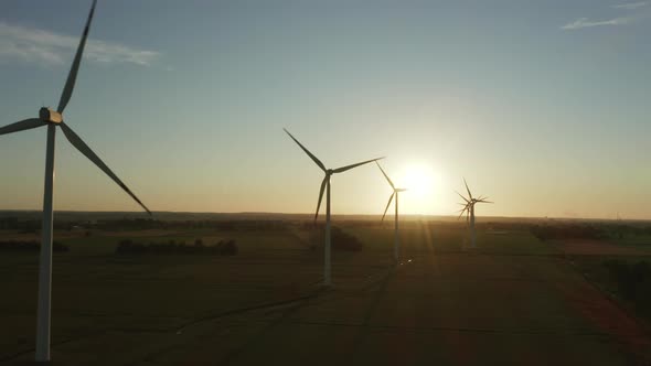 Cinematic Drone View of a Scenic View of a Wind Turbine Farm During Sunset