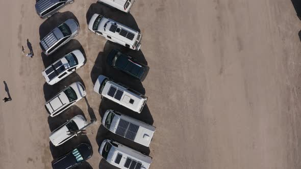 Top-down view of motorhomes outfitted with solar panels parked in the desert