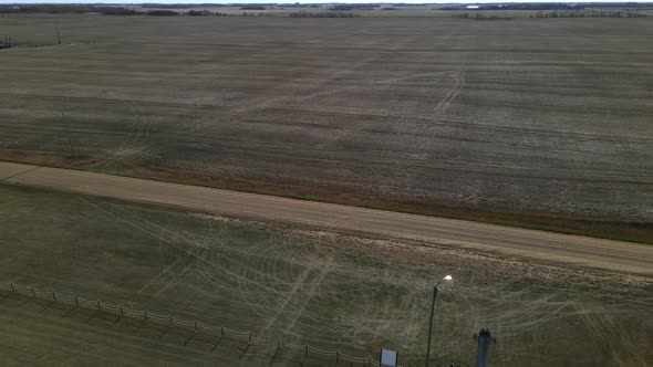 Backwards flying aerial footage revealing pretty church in remote location. White old wooden chapel