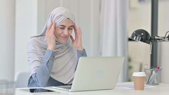Young Arab Woman with Laptop Having Headache