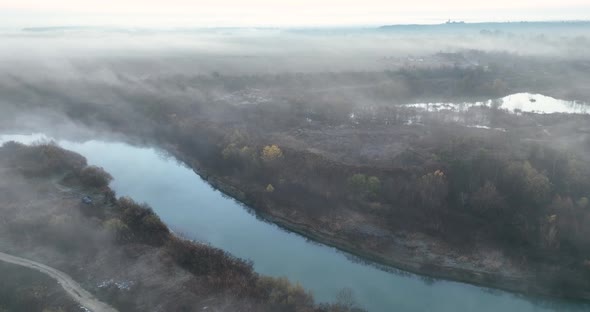 Aerial Drone View of Sunrise Over Misty River