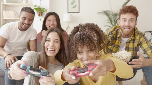 Group of Multiracial Young Friends Playing Video Games Together at Home