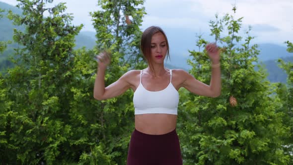 Sportswoman Warming Up Arms and Shoulders Before Training