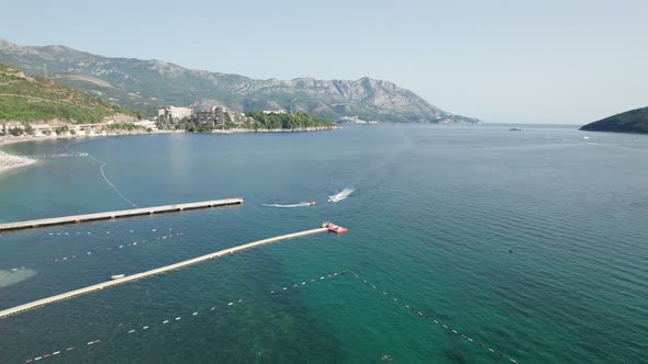 Aerial View of the Resort Sea Beach with Boats and Jet Skis in Budva Montenegro