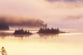 Islands with pine trees on a boundary waters lake shrouded in fog at dawn - PhotoDune Item for Sale