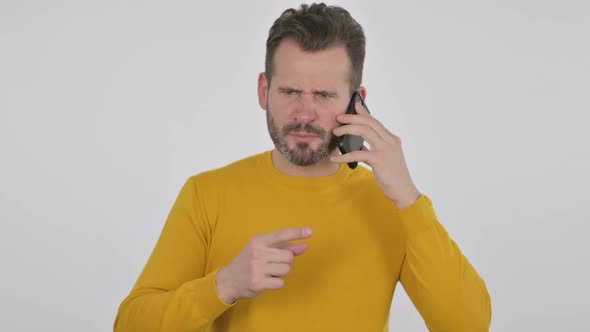 Portrait of Angry Middle Aged Man Talking on Smartphone