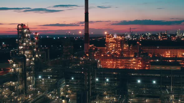Premises of the Petroleum Refinery with Electric Lights at Sunset