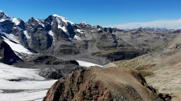 Aerial flyover around Fuorcla Trovat peak at Diavolezza in Engadin, Switzerland with 360 views of Pe