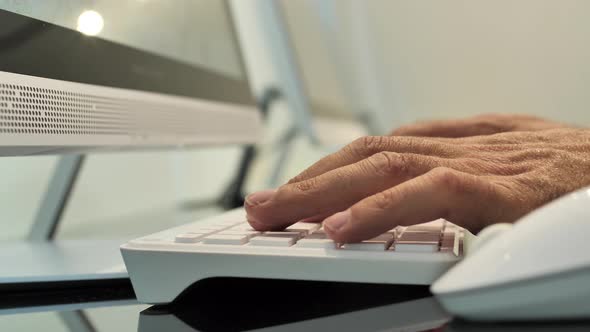 Hands typing on computer keypad, office workspace, modern technology in company