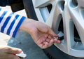 Woman inflates the tire. Woman checking tire pressure and pumping air into the tire of car wheel. - PhotoDune Item for Sale