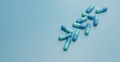 Blue capsule pills on blue background. Online pharmacy banner. Group of capsule pill. Pharmaceutical - PhotoDune Item for Sale