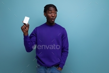 handsome african young man with money card in his hand