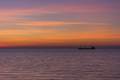 Bright twilight sunset sky over the sea. A ship on the horizon. - PhotoDune Item for Sale