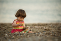 Toddler baby playing on a beach - PhotoDune Item for Sale