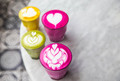 Beetroot, matcha,turmeric color lattes are on the marble table with art floor on the background - PhotoDune Item for Sale
